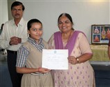 Student being falicitated by officials and guests