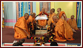 Sadhus honor Swamishri with a garland