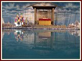 Swamishri engaged in his daily puja with the festival pool in the forefront
