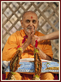 Sadhus honor Swamishri with a garland