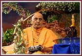 Swamishri lovingly sprays colored water on Shri Harikrishna Maharaj