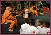 Swamishri smiles and laughs while playing the game 