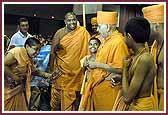 Evening,Balaks dressed as saints receive Swamishri to the Swagat Sabha 