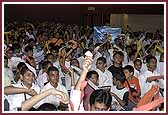 Evening,All balaks and balikas wave streamers in the air, welcoming Swamishri 