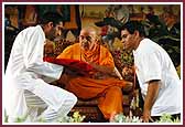 Morning,Swamishri gives his blessings for a publication about higher education 