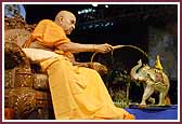 Evening ,Swamishri sprays Shri Harikrishna Maharaj with colored water 