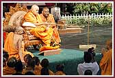 Evening ,Swamishri sprays saints with the sanctified water 