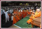 Evening ,Swamishri sprays saints with the sanctified water 