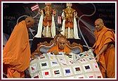 Swamishri is presented with a quilt representing different countries he has visited 