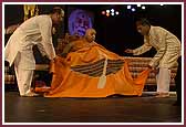Swamishri is presented with a shawl 