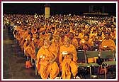 Saints and devotees perform aarti during the Guru Purnima assembly 