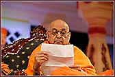 Swamishri reading letters during the sabha 