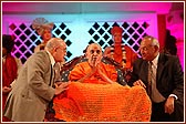  Members of the Board of Trustees place a shawl on Swamishri