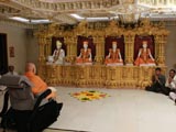 Swamishri engaged in darshan of Shri Guru Parampara