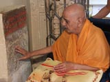  Swamishri reverentially touches sacred stone sanctified by Aksharbrahman Gunatitanand Swami