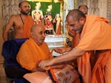  Sadhus honor Swamishri with a garland