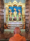  Swamishri engaged in darshan of Bhagwan Swaminarayan, Aksharbrahman Gunatitanand Swami and Shri Gopalanand Swami