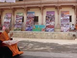 Swamishri observes panels with photographs of the Yuva Talim Kendra from 2007 onwards
