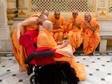 Swamishri in a divine, jovial mood with sadhus