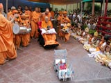 Swamishri drives the remote-controlled chariot of Harikrishna Maharaj accompanied by children