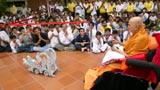 Devotees doing darshan of Swamishri driving the remote-controlled chariot of Shri Harikrishna Maharaj 