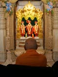 Swamishri engrossed in darshan of Bhagwan Swaminarayan, Aksharbrahman Gunatitanand Swami and Shri Gopalanand Swami 