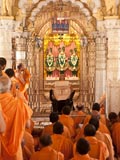 Swamishri engrossed in darshan of Bhagwan Swaminarayan, Aksharbrahman Gunatitanand Swami and Shri Gopalanand Swami 