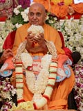  Swamishri is honored with garlands and a specially made bunch of flowers