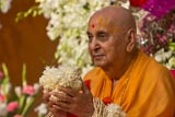  Swamishri is honored with garlands and a specially made bunch of flowers