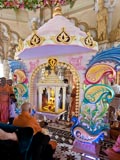  Swamishri engaged in darshan of Thakorji in a decorative hindolo