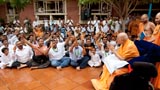 Devotees sing kirtans before Swamishri