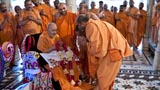 Sadhus honor Swamishri with a garland