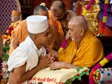  Swamishri initiates a youth, giving him parshadi diksha