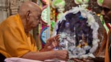  Swamishri swings Shri Harikrishna Maharaj in a decorative hindolo