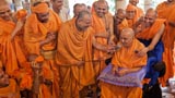 Swamishri with sadhus beneath the mandir dome