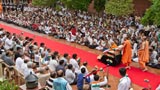  Devotees welcome Swamishri while waving the Indian tricolor 
