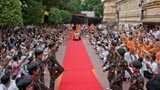  Devotees welcome Swamishri while waving the Indian tricolor  