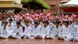  Students from APC Atladra wave BAPS flags