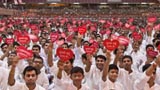  Youths in the audience wave heart-shaped cards