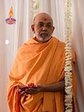  A sadhu holding a lamp signifying Diwali, the festival of lights
