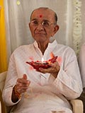  A devotee holding a lamp signifying Diwali