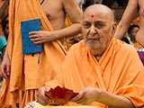  Swamishri holds a lamp in his hand