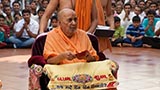  Swamishri holds a lamp in his hand