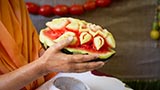  Swamishri holding various fruits and vegetables offered to Thakorji