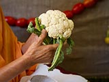  Swamishri holding various fruits and vegetables offered to Thakorji