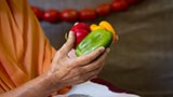  Swamishri holding various fruits and vegetables offered to Thakorji