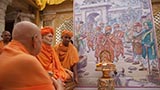 Swamishri viewing a presentation on the divine work of Shastriji Maharaj