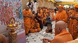 Swamishri viewing a presentation on the divine work of Shastriji Maharaj