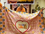 Senior sadhus honor Swamishri with shawls and garland