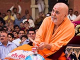  Swamishri plays drum sticks on the cake decorations